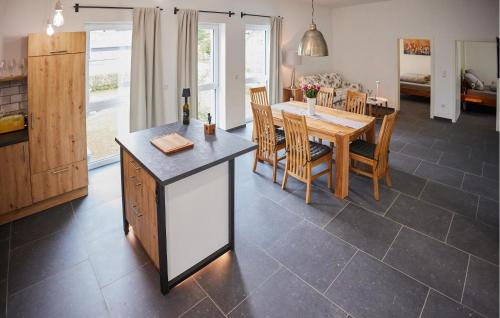a kitchen and dining room with a table and chairs at Pet Friendly Apartment In Attendorn in Attendorn