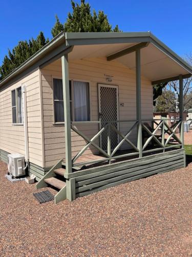 a mobile home with a porch and a porch at Denman Van Village in Denman
