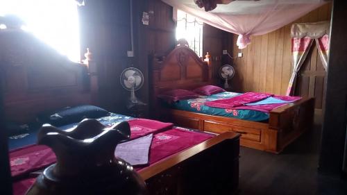 a bedroom with two twin beds and a window at Tonle Mekong Homestay in Krong Kracheh