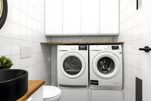 a white laundry room with a washer and dryer at Þingvallavatn Hot Tub Sauna 2024 Built Cabin in Veiðilundur