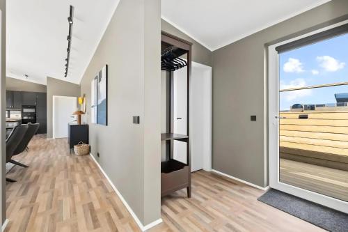 an open living room with a large window and a desk at Þingvallavatn Hot Tub Sauna 2024 Built Cabin in Veiðilundur