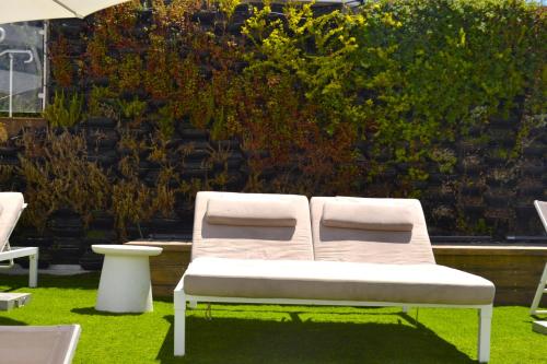 a white bench sitting on the grass in a yard at סי סייד, אילת - סמואל - Sea Side Eilat in Eilat