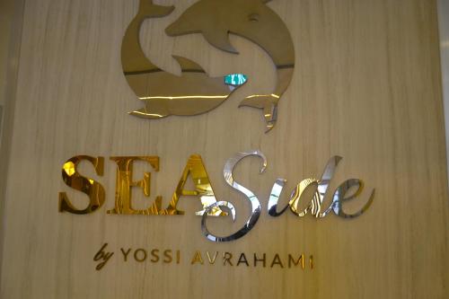a sign for a store with a dolphin on it at סי סייד, אילת - סמואל - Sea Side Eilat in Eilat