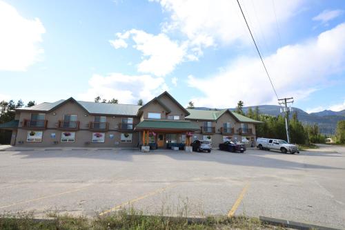 a large building with a parking lot in front of it at Glacier Mountain Lodge in Blue River