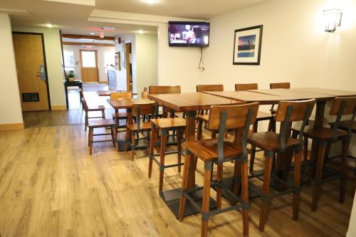 a dining room with a large wooden table and chairs at Glacier Mountain Lodge in Blue River
