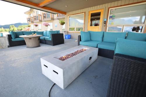 a patio with couches and a fire pit at Glacier Mountain Lodge in Blue River