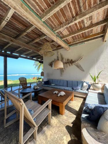 a living room with a couch and a table at Arrecifes Refugio Natural in Santa Marta