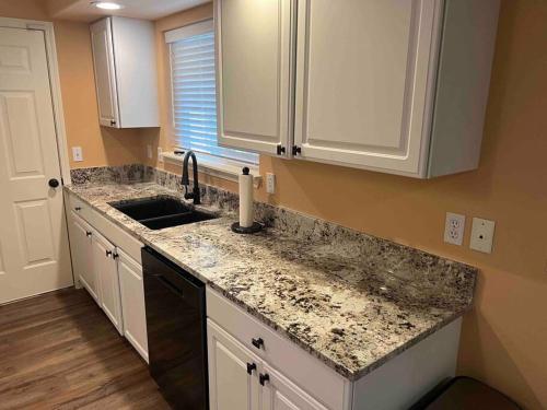 a kitchen with a sink and a counter top at Solar Half-Plex with Chic Style in Country Glen in Keizer