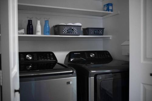 a kitchen with a stove and a refrigerator at Solar Half-Plex with Chic Style in Country Glen in Keizer
