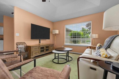 a living room with a couch and a tv at Solar Half-Plex with Chic Style in Country Glen in Keizer