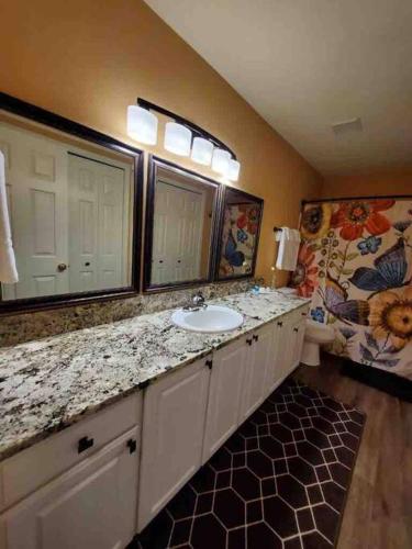a bathroom with a sink and a mirror at Solar Half-Plex with Chic Style in Country Glen in Keizer