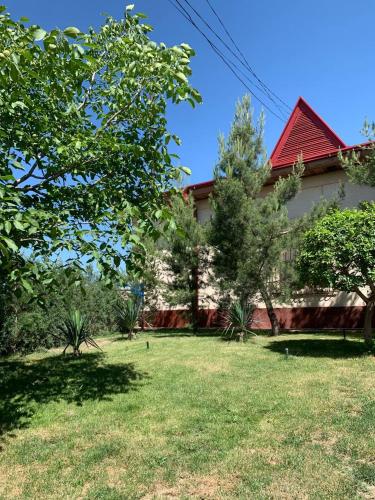 a house with a yard in front of it at UYUT INN Hotel in Samarkand