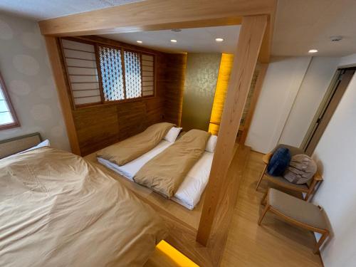 a bedroom with two beds and a mirror in it at 日月庵 BnB Sunmoon in Kanazawa