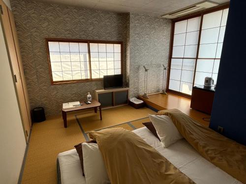 a living room with a white couch and a table at 日月庵 BnB Sunmoon in Kanazawa