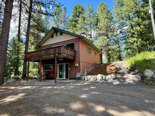 a small house with a deck in the woods at The Park Chalet by Casago McCall - Donerightmanagement in McCall