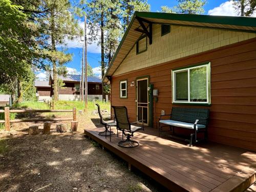 a house with a bench on a wooden deck at The Park Chalet by Casago McCall - Donerightmanagement in McCall