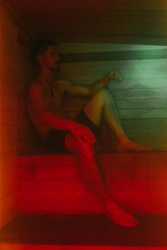 a painting of a man sitting on the stairs at Wake up and Thrive in Raglan