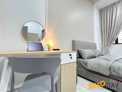 a bedroom with a desk with a bed and a mirror at Youth City Residence Family Suite KLIA AEON Mall Nilai USIM in Nilai