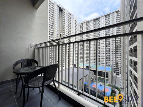 a balcony with a table and chairs and a view of a building at Youth City Residence Family Suite KLIA AEON Mall Nilai USIM in Nilai