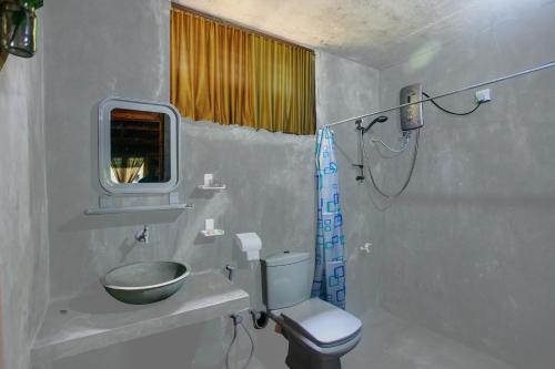 a bathroom with a toilet and a sink and a shower at Ella Ecolodge in Ella