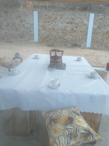 a large white table with cups and chairs on it at MAy Loviou in Namora