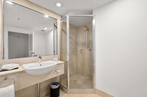 a bathroom with a sink and a shower at Crowne Plaza Surfers Paradise by IHG in Gold Coast