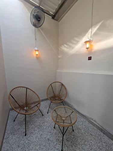 two chairs and a table in a room at Guesthouse Jogja Selatan 2 Yogya South Bantul - Casa of Joy in Bantul