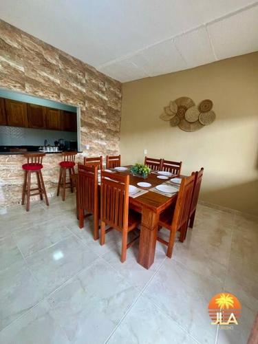 a dining room with a wooden table and chairs at Casa na Praia do Francês in Praia do Frances