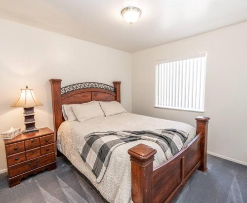 a bedroom with a bed and a nightstand and a window at Large Family Home with Game Room in Page