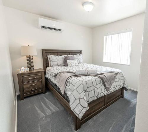 a white bedroom with a bed and a night stand at Large Family Home with Game Room in Page