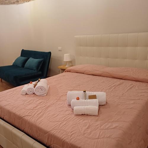 a bedroom with a bed with towels on it at Loft Gioia in Perugia