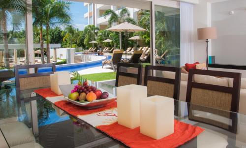 a table with a bowl of fruit on top of it at Marival Distinct All-Suites & World Spa - Handwritten Collection in Nuevo Vallarta 