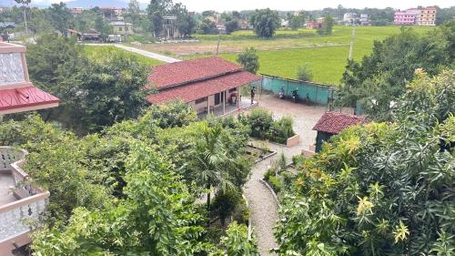 an overhead view of a house with a garden and trees at Tree Tops Retreat B&B in Sauraha