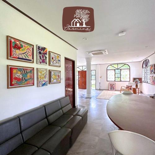 a living room with a couch and a table at Bann Jasmine Khaoyai in Mu Si