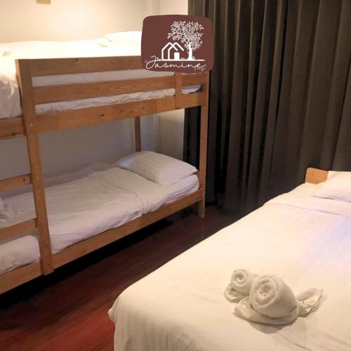 two bunk beds in a room with towels on a bed at Bann Jasmine Khaoyai in Mu Si