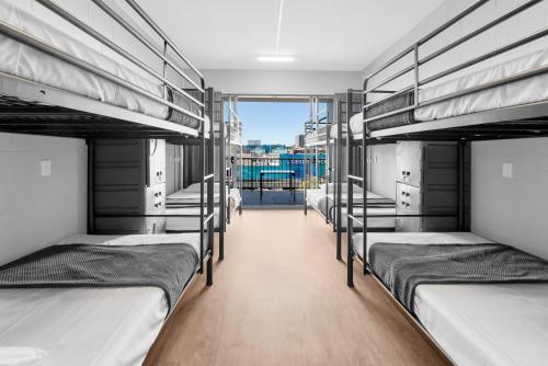 a group of bunk beds in a room at Gilligan's Hotel & Resort Cairns in Cairns