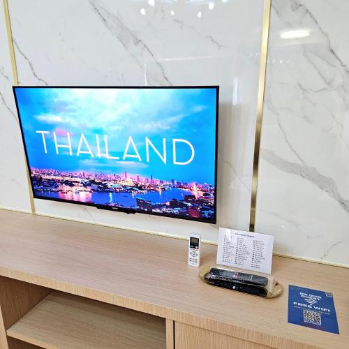 a flat screen tv sitting on top of a table at Omni Suites 1Bed #702A in Bangkok