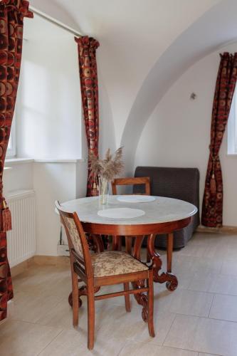 a dining room with a table and two chairs at Zamość Dwór Udrycze in Udrycze