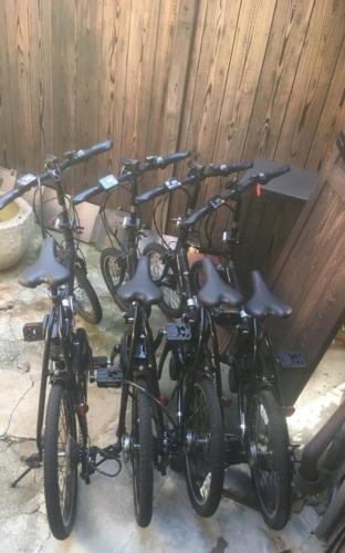 a group of bikes parked next to a fence at Kiyomizuan 清水庵 車庫2台可 ビフォアアフターの匠 坂田基禎さん改築の京町家 in Kyoto