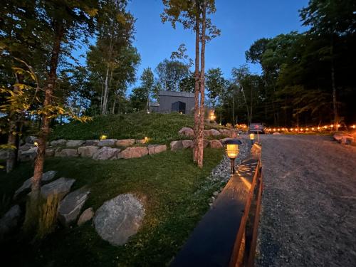 a yard with lights on the side of a road at Luxury Mountain Retreat with Spa Near Mont Tremblant in La Conception
