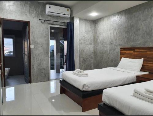 a bedroom with two beds and a balcony at Life koh tao resort in Koh Tao