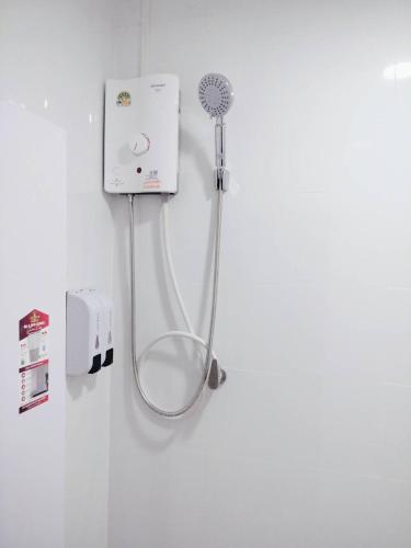 a shower with a hose attached to a wall at D72 Family House, 8PAX 3BR Hat Yai Middle Town in Hat Yai