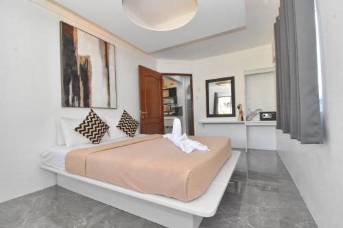 a bedroom with a large bed in a room at Villa Sunset Boracay in Boracay