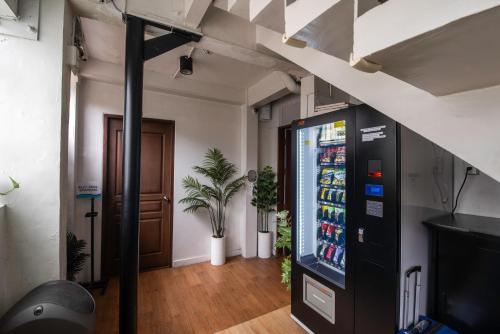 a drink vending machine in a room with a door at Homey and Cozey Poblacion Makati S01 in Manila