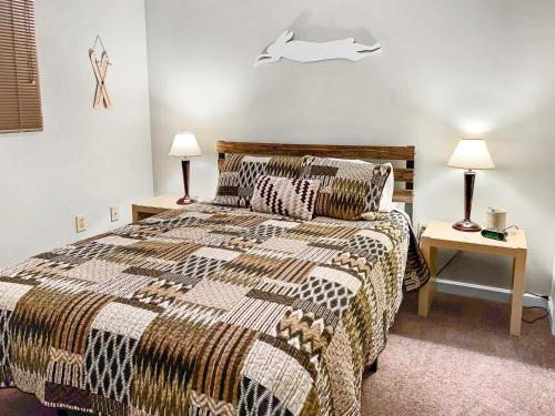 a bedroom with a bed and two lamps on tables at ML309 Back Exit Leads To Slopes Gated Parking Wi-Fi in Snowshoe