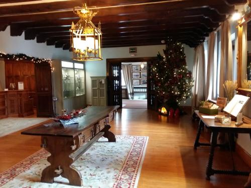 a living room with a table and a christmas tree at Parador de Gredos in Navarredonda de Gredos