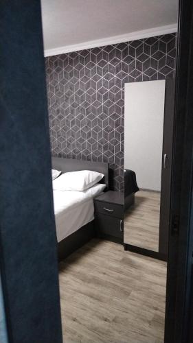 a bedroom with a bed and a mirror at Pearl sevan in Sevan