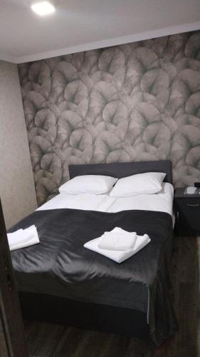 a bed with two white pillows on top of it at Pearl sevan in Sevan