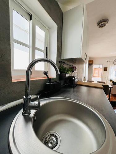 a kitchen sink with a faucet in a kitchen at La Casa de Eloisa in Santa Cruz de Tenerife