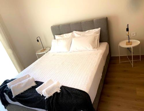 a bedroom with a large bed with two pillows at Adeste to Ioannina Apartment in Ioannina